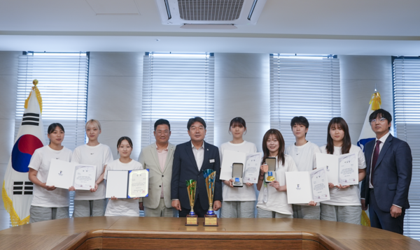 동래구 태권도 실업팀 선수단이 6월 전국 규모 태권도대회에서 획득한 메달과 상장을 들고 관계자들과 기념촬영을 하고 있다.(사진_동래구청)