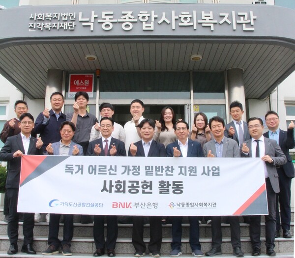 21일 가덕도신공항건설공단과 BNK부산은행 임직원들이 낙동종합사회복지관에서 강서구 지역 취약계층을 위한 '도시락 나눔' 사회공헌 활동에 뜻을 모으고 기념촬영을 하고 있다.(사진_가덕도신공항건설공단)