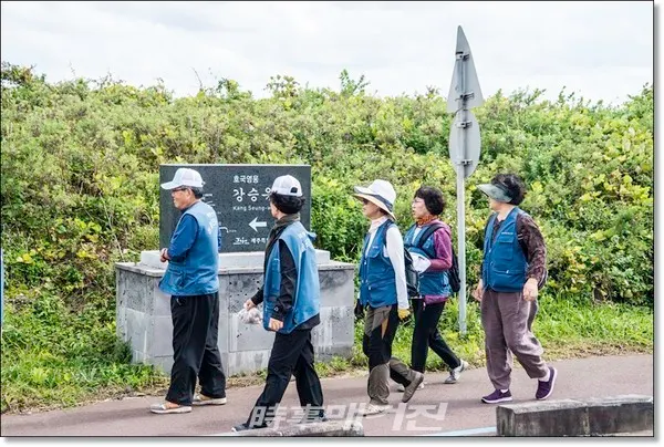유족회원들이 성산읍 오조리 식산봉 해안가를 걷고 있다.(대한민국전몰군경유족회 제주지부 사진제공)