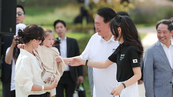 윤석열 대통령과 부인 김건희 여사가 26일 서울 용산어린이정원 분수정원에서 열린 다둥이가족 초청행사에서 어린이들과 인사하고 있다.(사진_대통령실)
